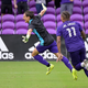 Orlando City defender Rodrigo Schlegel, left, celebrates after blocking the final New York City FC penalty kick during overtime of an MLS soccer playoff match.